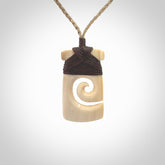 Hand carved Woolly Mammoth Tusk toki with koru pendant. Toki with koru necklace carved from ancient woolly mammoth tusk. Provided with adjustable cord and packaged in a woven kete pouch.